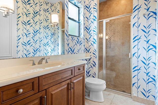 bathroom with toilet, tile patterned flooring, vanity, and walk in shower