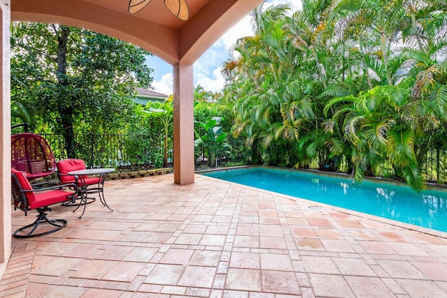 view of pool featuring ceiling fan and a patio area