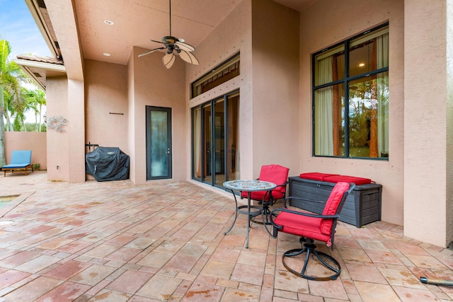 view of patio with area for grilling and ceiling fan