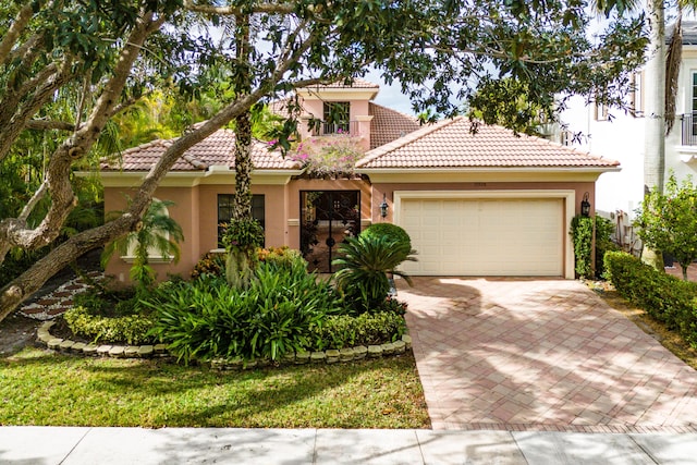 mediterranean / spanish-style house with a garage