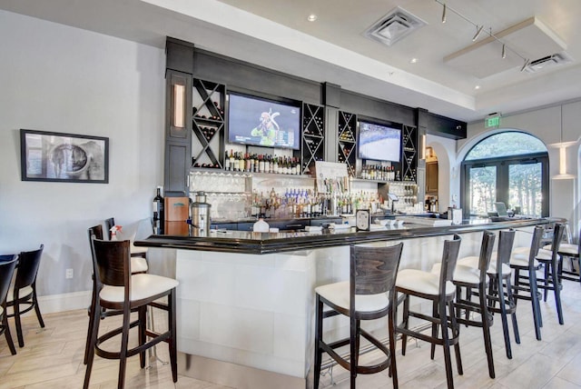 bar featuring light hardwood / wood-style floors