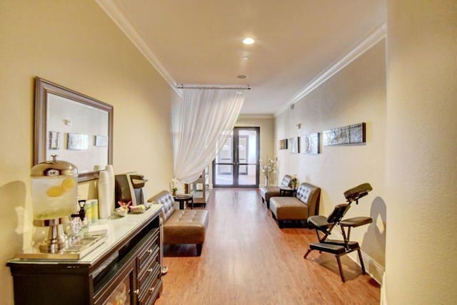 interior space with french doors, light hardwood / wood-style flooring, and ornamental molding