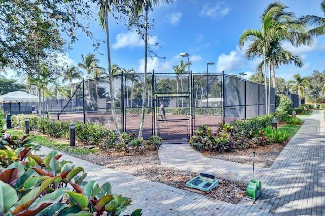 view of community featuring tennis court