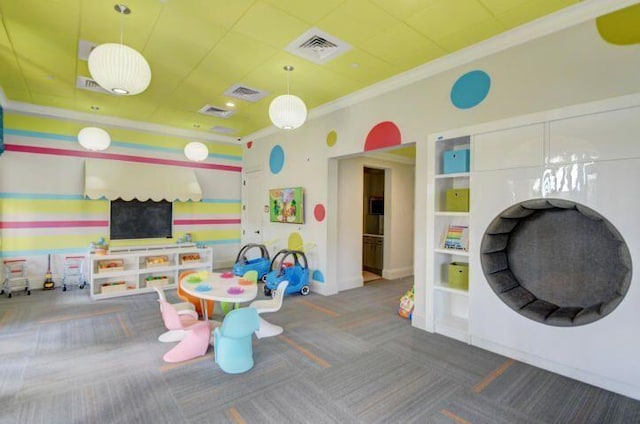 recreation room featuring carpet and ornamental molding