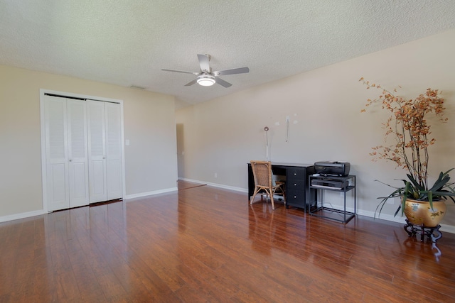 office space featuring a textured ceiling, dark hardwood / wood-style floors, and ceiling fan