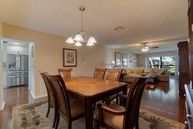 dining room featuring a textured ceiling, ceiling fan with notable chandelier, and dark hardwood / wood-style flooring