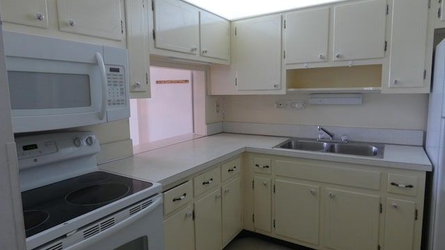 kitchen with white cabinets, white appliances, and sink