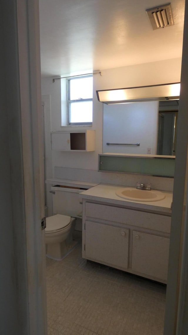 bathroom with vanity and toilet