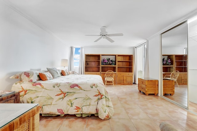 bedroom with crown molding, a closet, light tile patterned flooring, and ceiling fan