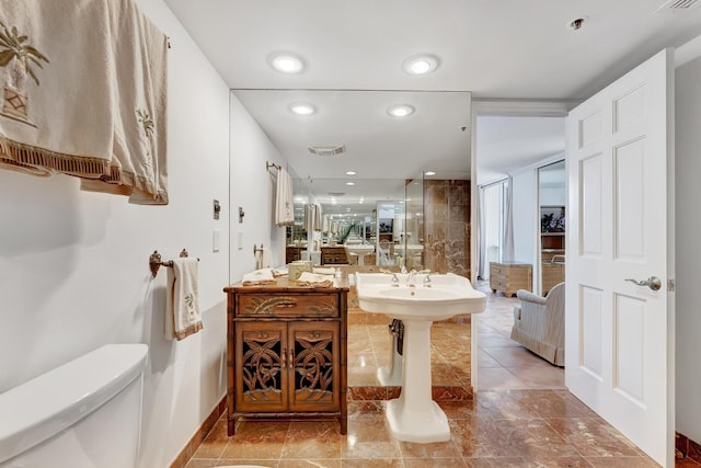 bathroom with toilet and a shower