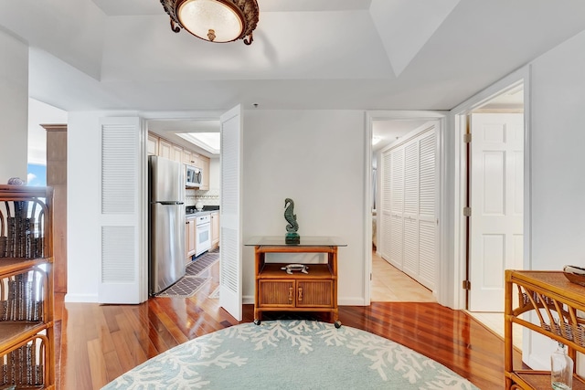 corridor with light hardwood / wood-style floors