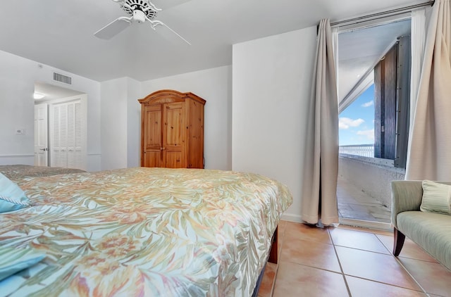 tiled bedroom featuring a closet and ceiling fan