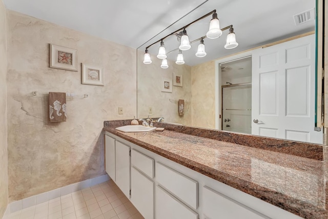 bathroom featuring vanity, tile patterned flooring, and a shower with door