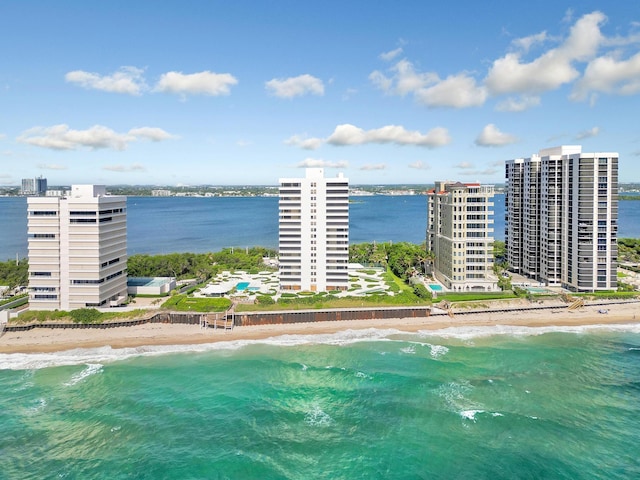 drone / aerial view with a water view and a beach view