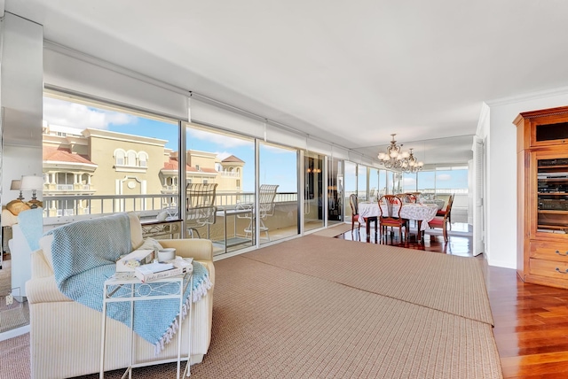 sunroom / solarium featuring a notable chandelier