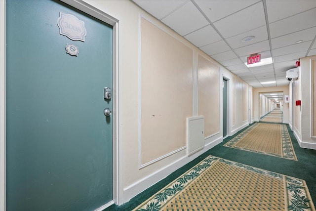 hallway featuring a drop ceiling