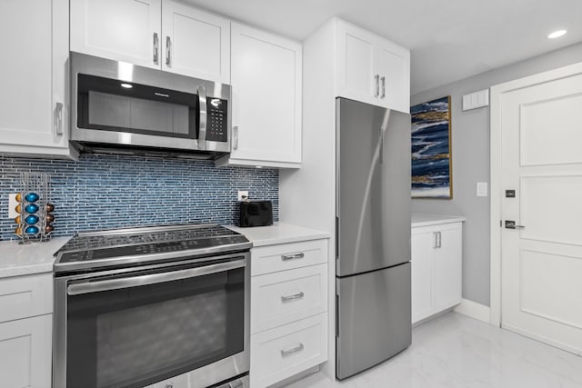 kitchen featuring stainless steel appliances, tasteful backsplash, and white cabinets