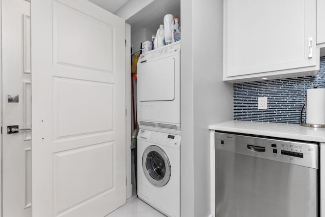 washroom featuring stacked washer / drying machine