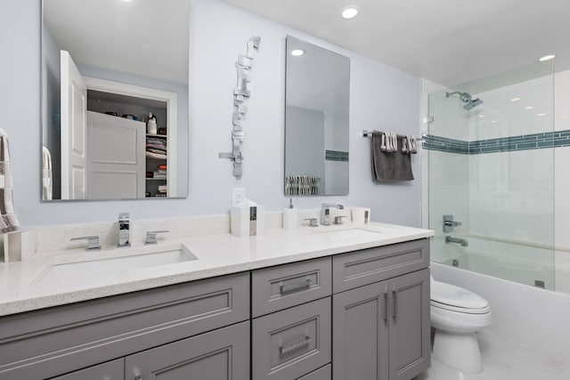 full bathroom with toilet, tiled shower / bath combo, and vanity