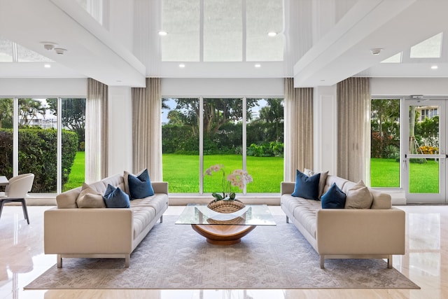 living room featuring a towering ceiling and a wealth of natural light