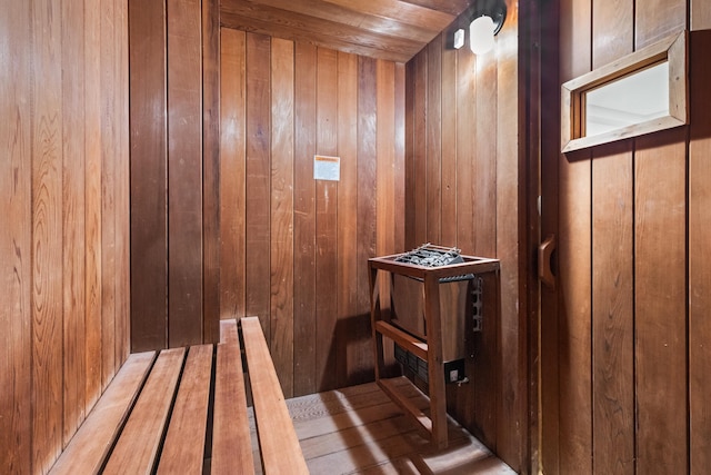 view of sauna featuring wood walls and wooden ceiling