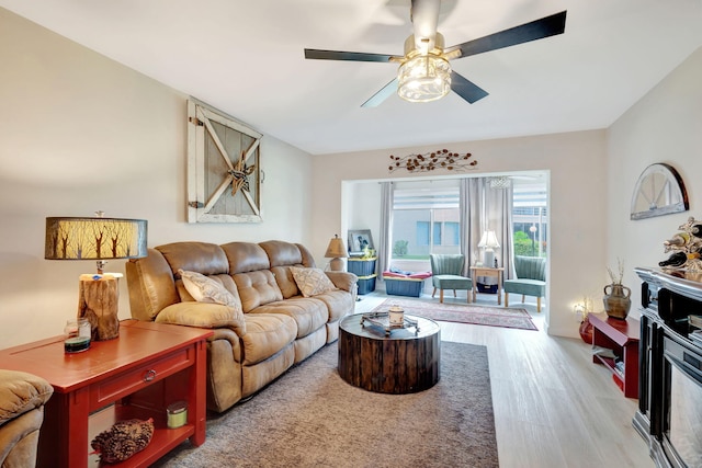 living room featuring light hardwood / wood-style floors and ceiling fan