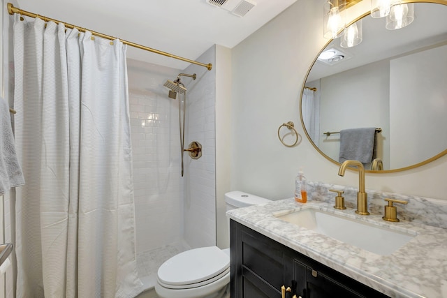 bathroom featuring vanity, toilet, and walk in shower