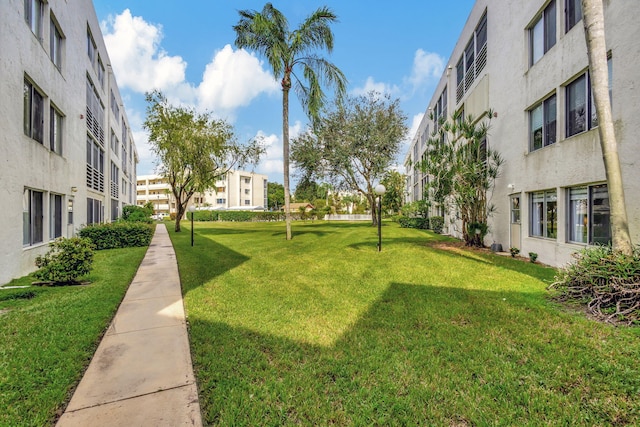 view of home's community with a yard