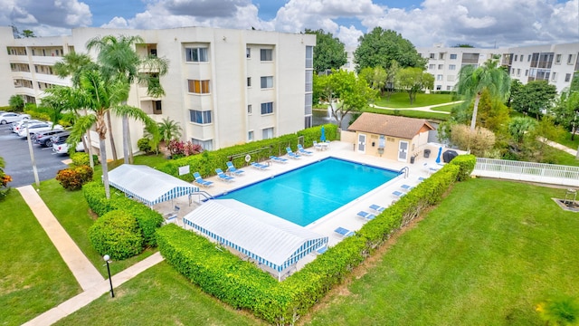 view of swimming pool with a yard and a patio