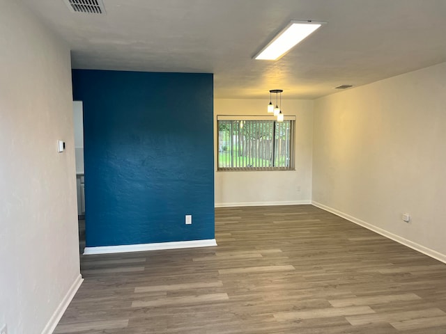 empty room with hardwood / wood-style floors