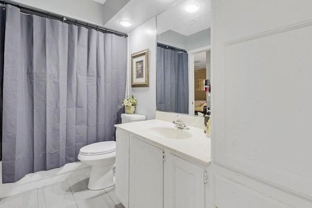 bathroom featuring tile patterned floors, toilet, walk in shower, and vanity