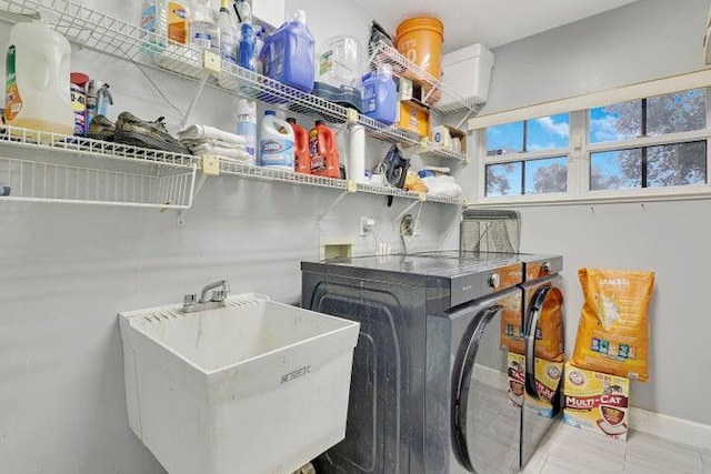 washroom featuring washing machine and dryer and sink