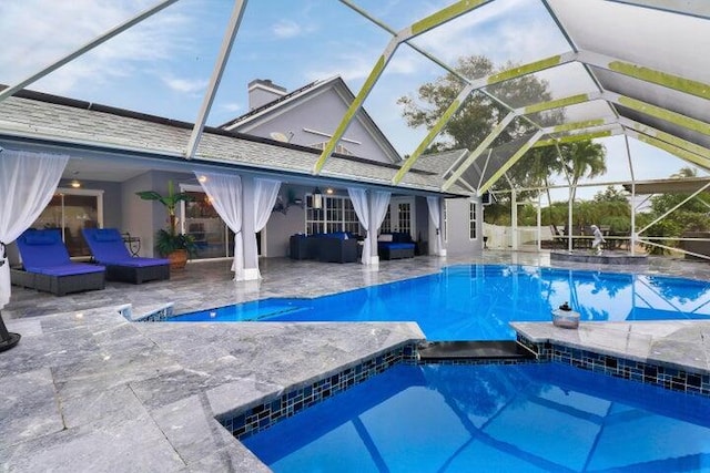 view of swimming pool with a patio, an in ground hot tub, and a lanai