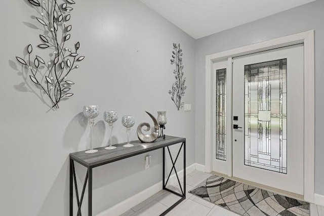 foyer with vaulted ceiling and a textured ceiling