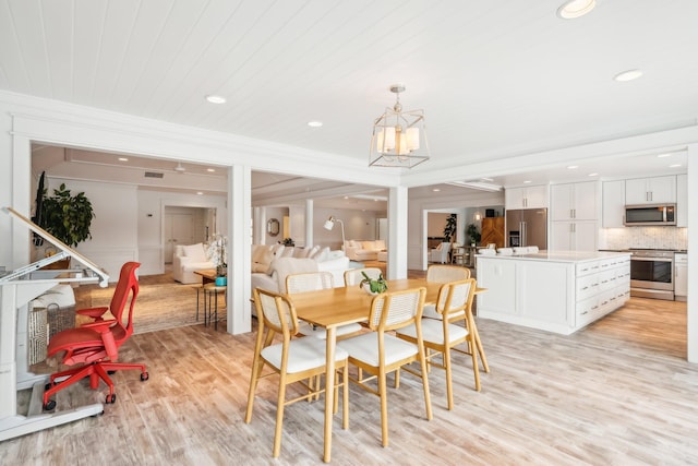 dining room with wooden ceiling, an inviting chandelier, light hardwood / wood-style flooring, and crown molding