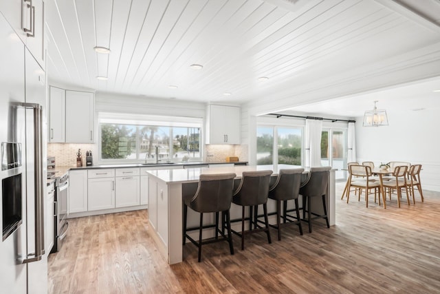 kitchen with white cabinetry, plenty of natural light, and a center island