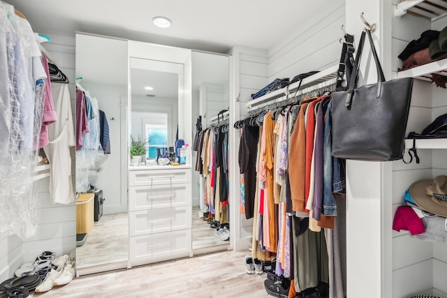 spacious closet featuring light hardwood / wood-style floors