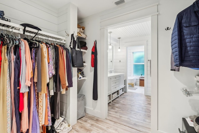 spacious closet featuring light hardwood / wood-style floors