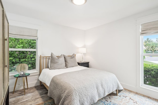 bedroom featuring hardwood / wood-style floors and multiple windows