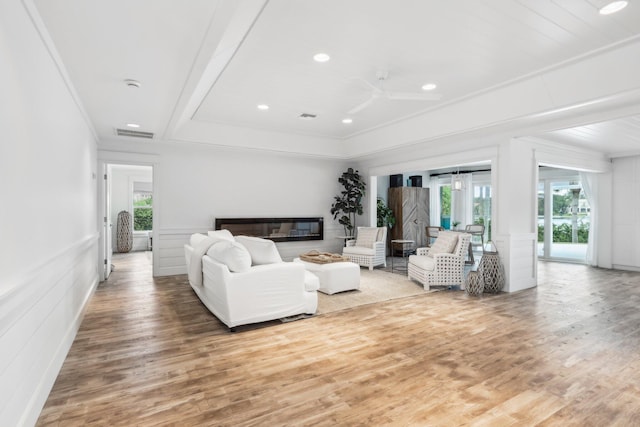 living room featuring ornamental molding, hardwood / wood-style floors, and ceiling fan