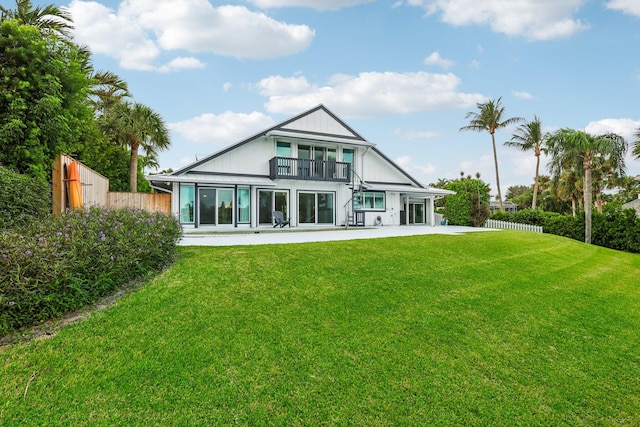 rear view of property with a patio and a yard