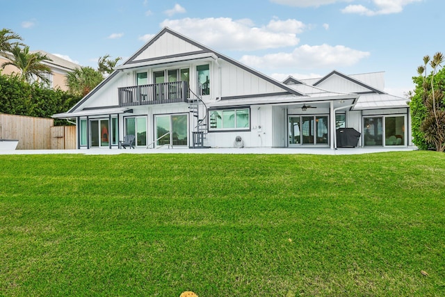 back of house featuring a patio, ceiling fan, and a yard