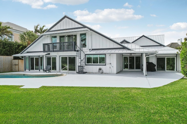 rear view of house featuring a yard and a patio area