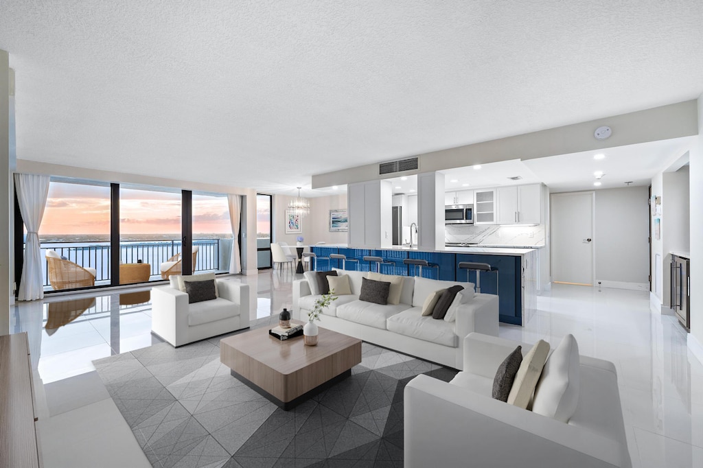 living room featuring a water view and a textured ceiling