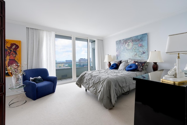 carpeted bedroom featuring ornamental molding and access to outside