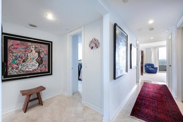 hallway featuring light tile patterned floors