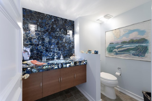 bathroom featuring vanity, toilet, and tile patterned floors