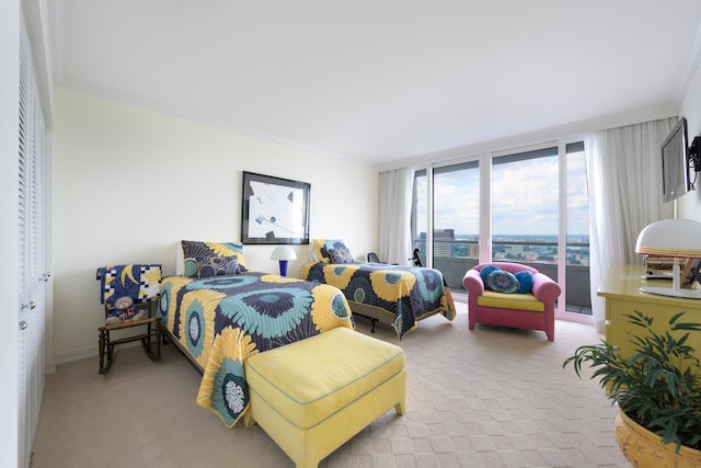 carpeted bedroom with ornamental molding and floor to ceiling windows