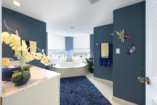 bathroom featuring hardwood / wood-style floors and a tub