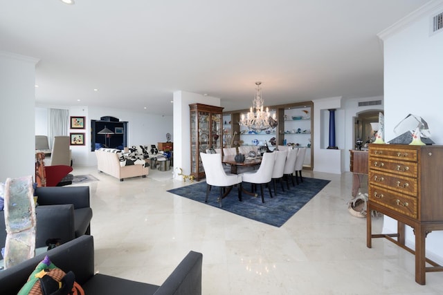 dining space featuring crown molding and an inviting chandelier